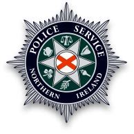 Badge of the Police Service of Northern Ireland with a red cross, harp, and scales symbols.