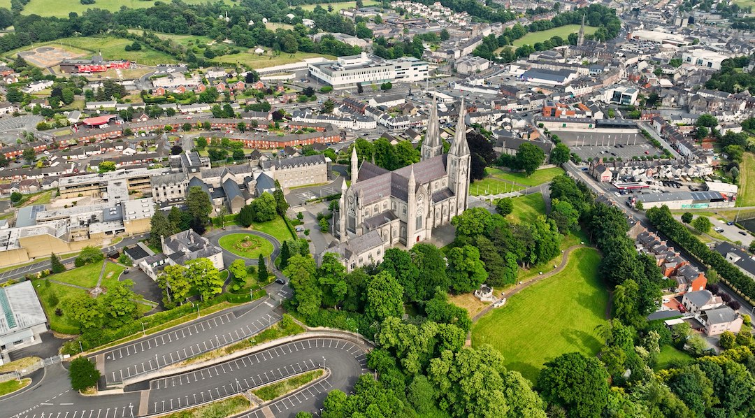 Aerial view of St Patrick’s Cathedral surrounded by urban Armagh and tree-lined streets.
