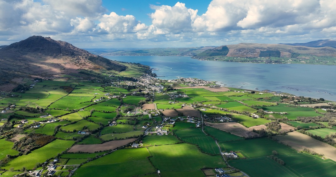Patchwork of green fields stretching towards Carlingford Lough beneath the slopes of Slieve Foye.