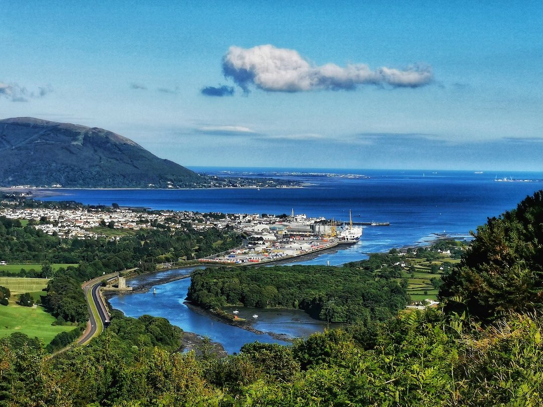 Aerial view of Newry Canal meeting Carlingford Lough with the Mourne Mountains in the background.
