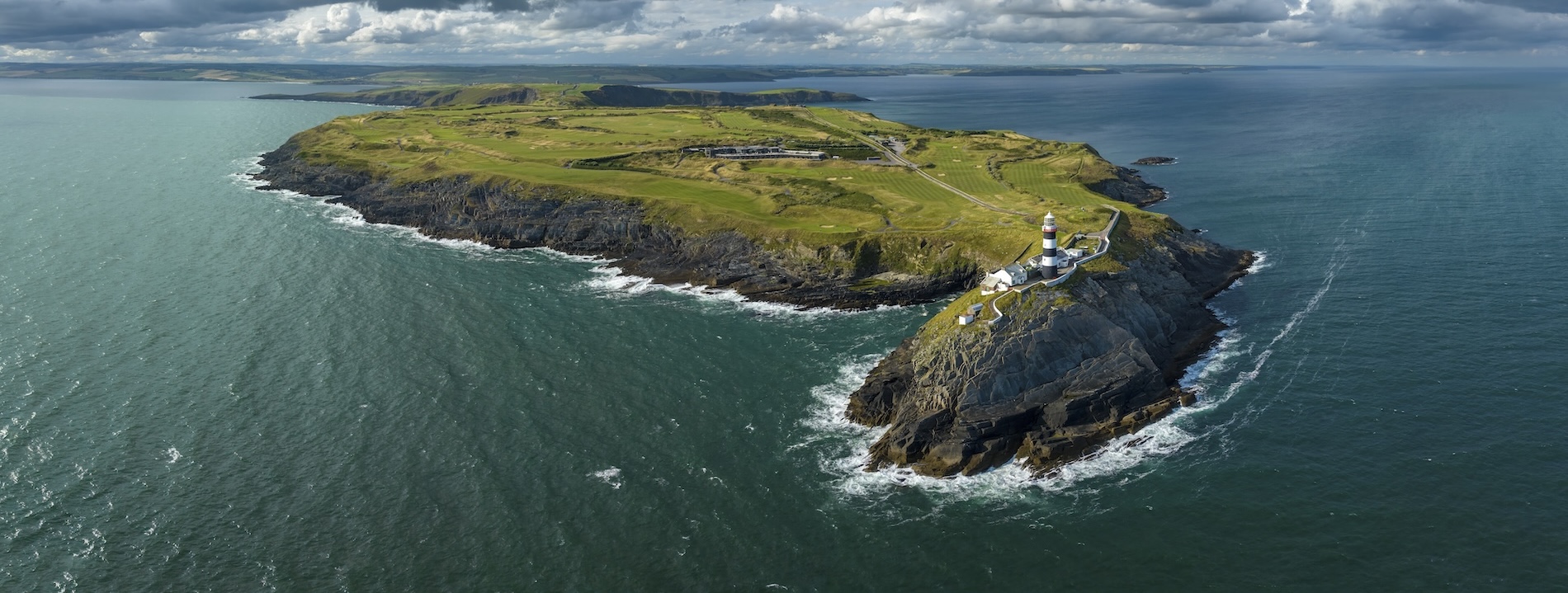 Aerial view of the Old Head of Kinsale lighthouse and cliffs, County Cork.