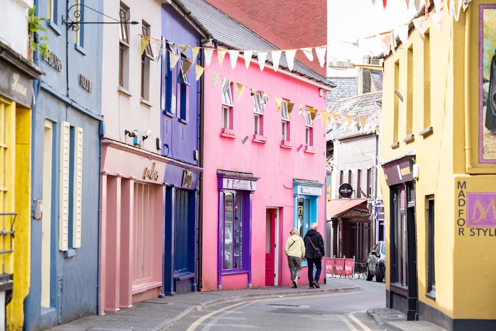 Colourful houses and bunting along a narrow street in Kinsale, County Cork, Ireland.