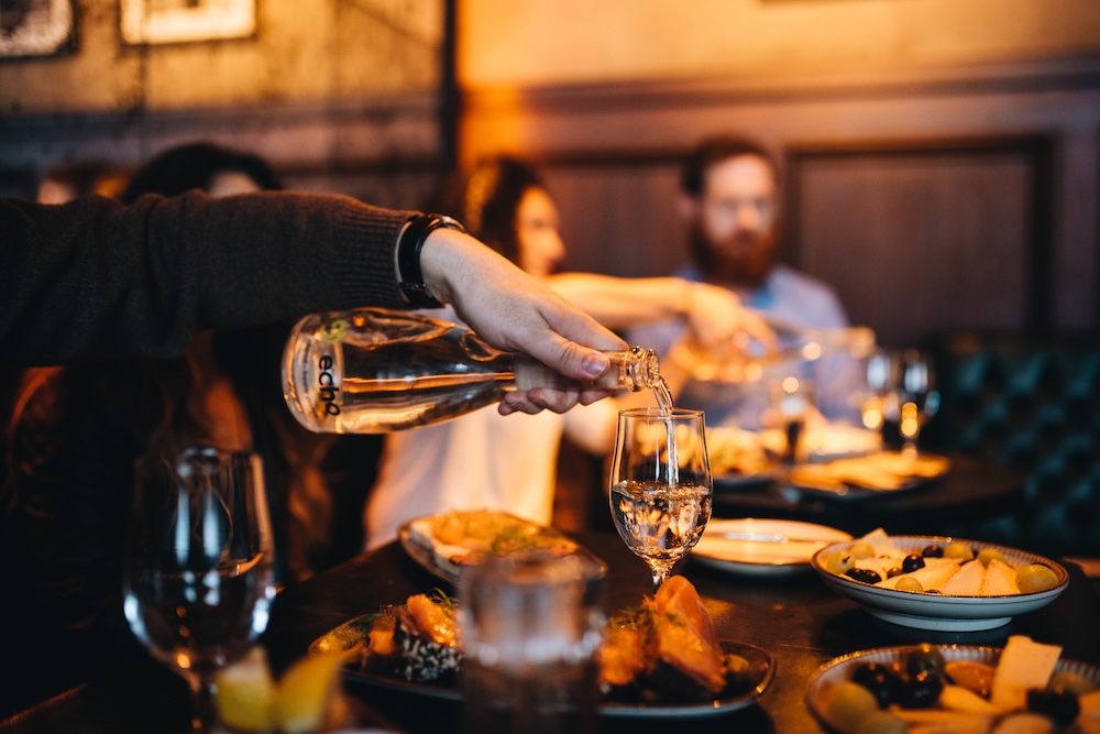 People enjoying drinks and food on a Cork food tasting tour.