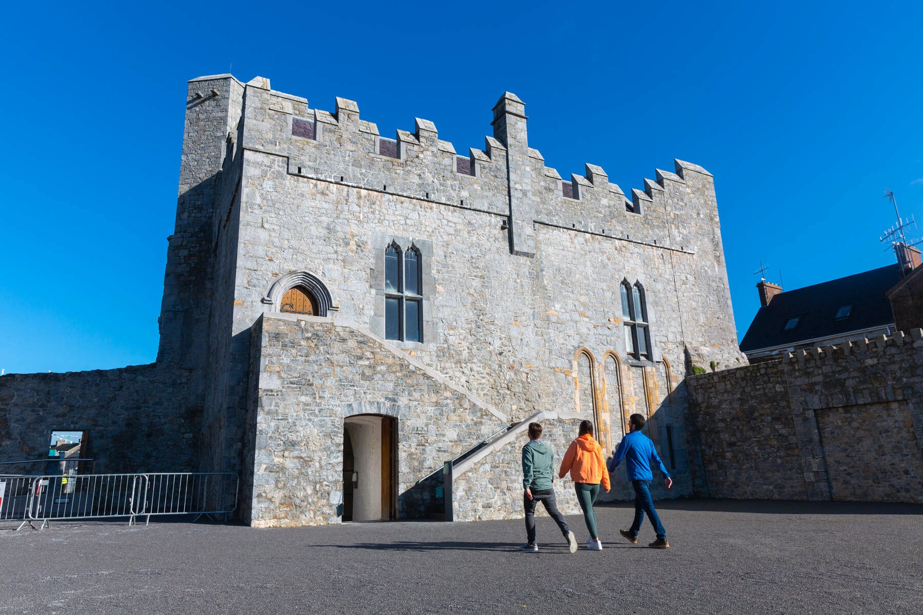 Visitors walking past the stone Desmond Castle in Newcastle West.