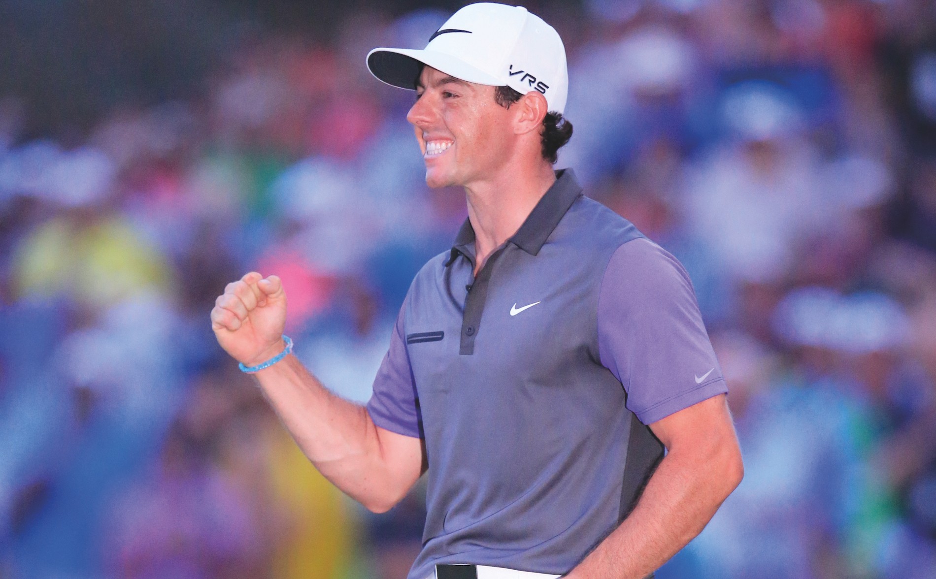 Golfer Rory McIlroy smiling and celebrating during a tournament.