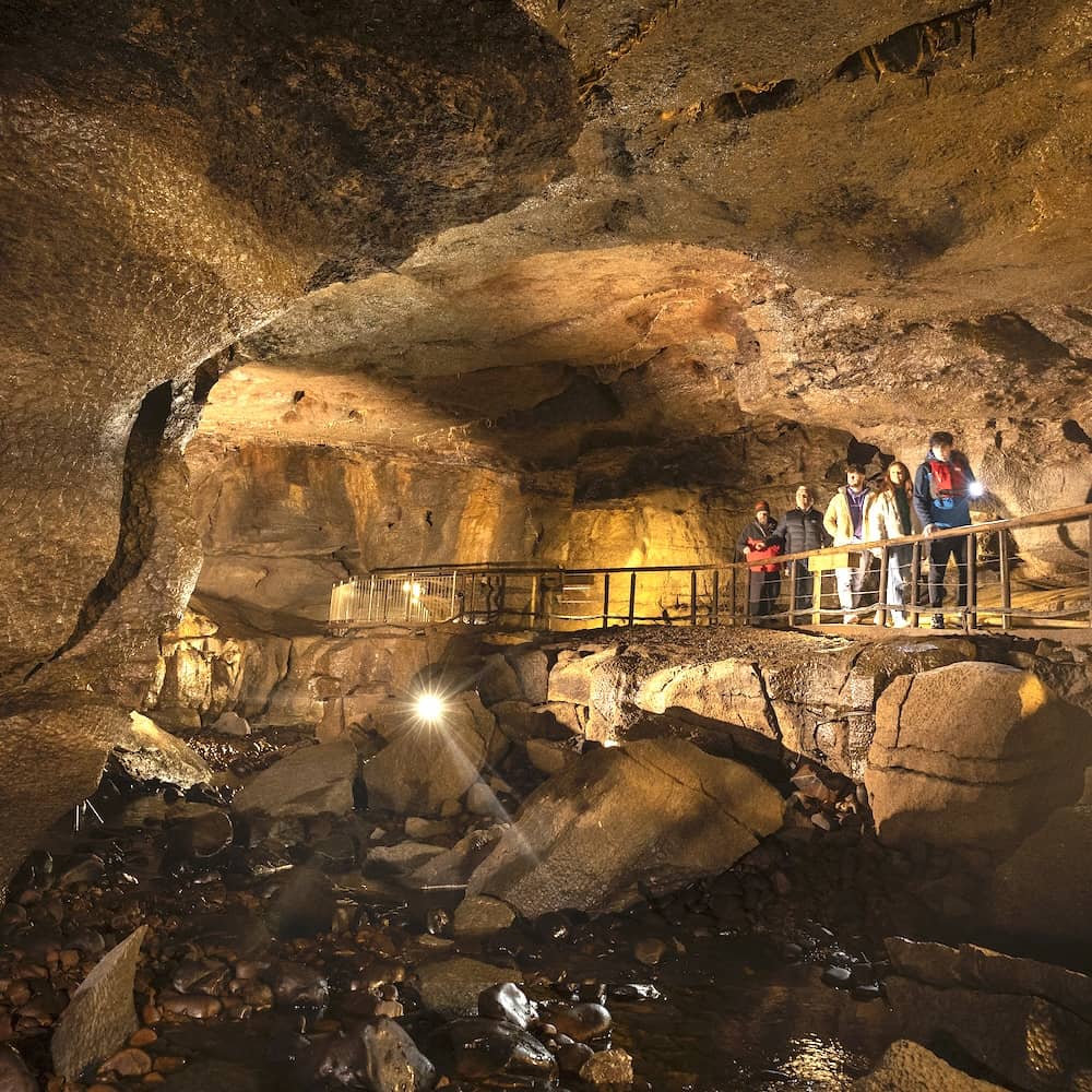 Visitors exploring the illuminated Marble Arch Caves on a guided underground tour in County Fermanagh.