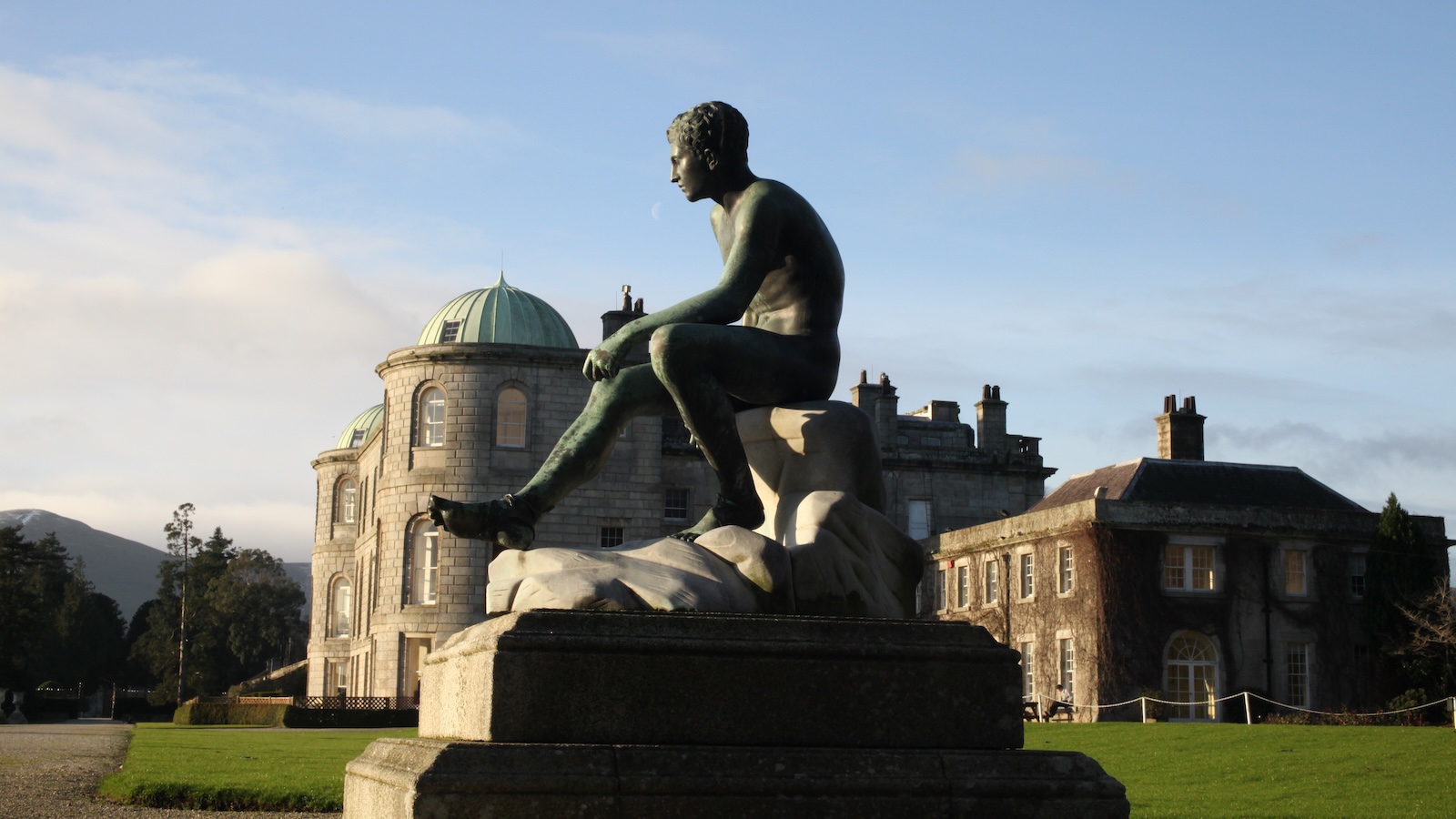 Statue on terrace at Powerscourt House with domed architecture in County Wicklow.