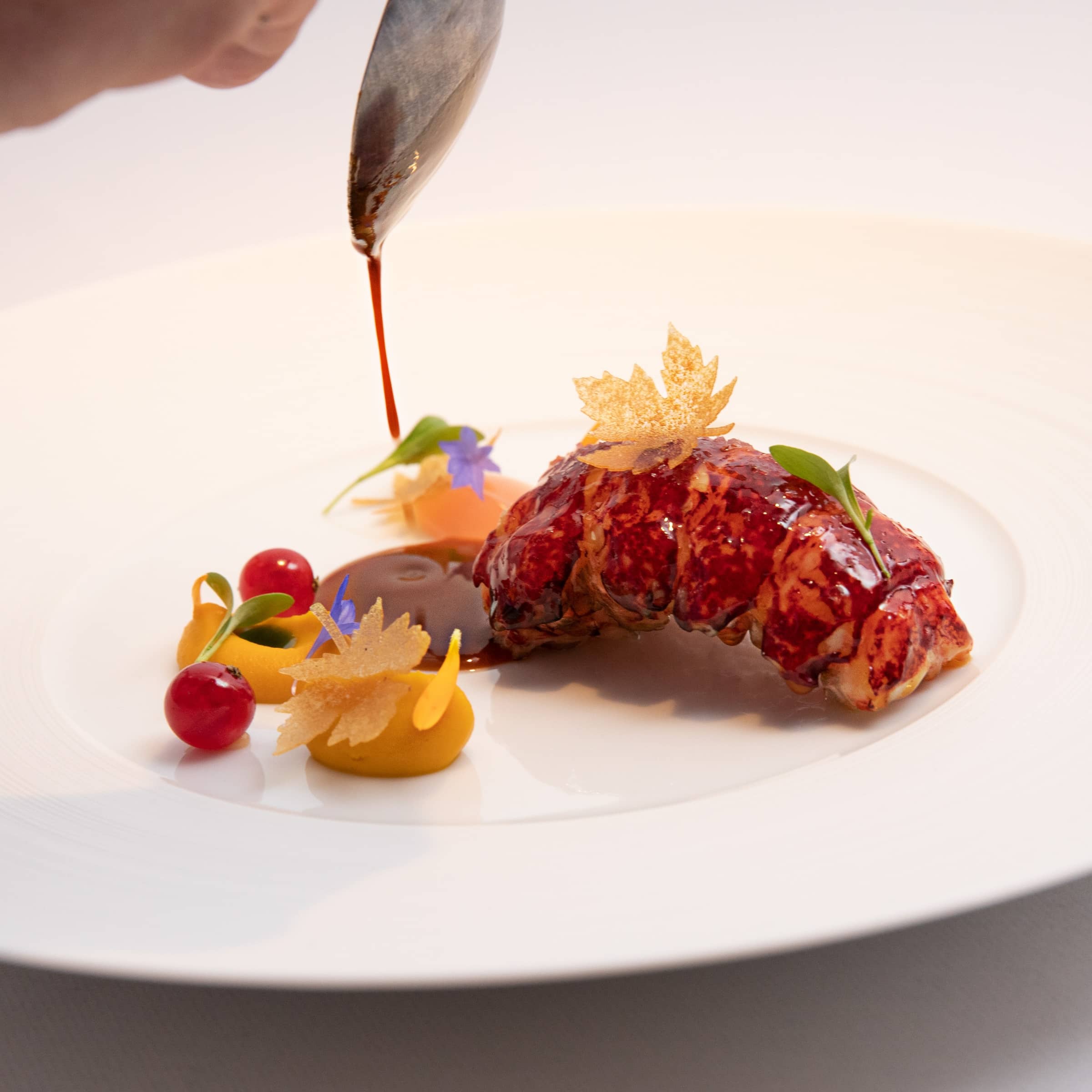 Lobster dish at Chapter One in Dublin, elegantly plated with seasonal garnishes and rich sauce.