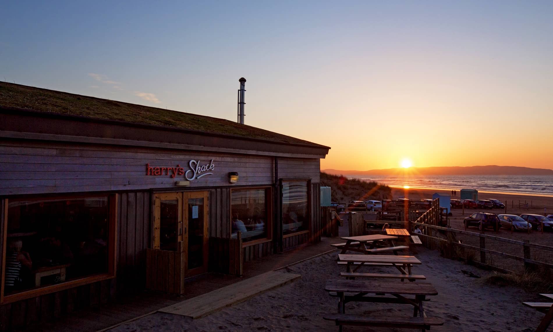 Harry's Shack restaurant overlooking Portstewart Strand at sunset on Northern Ireland's Causeway Coast.