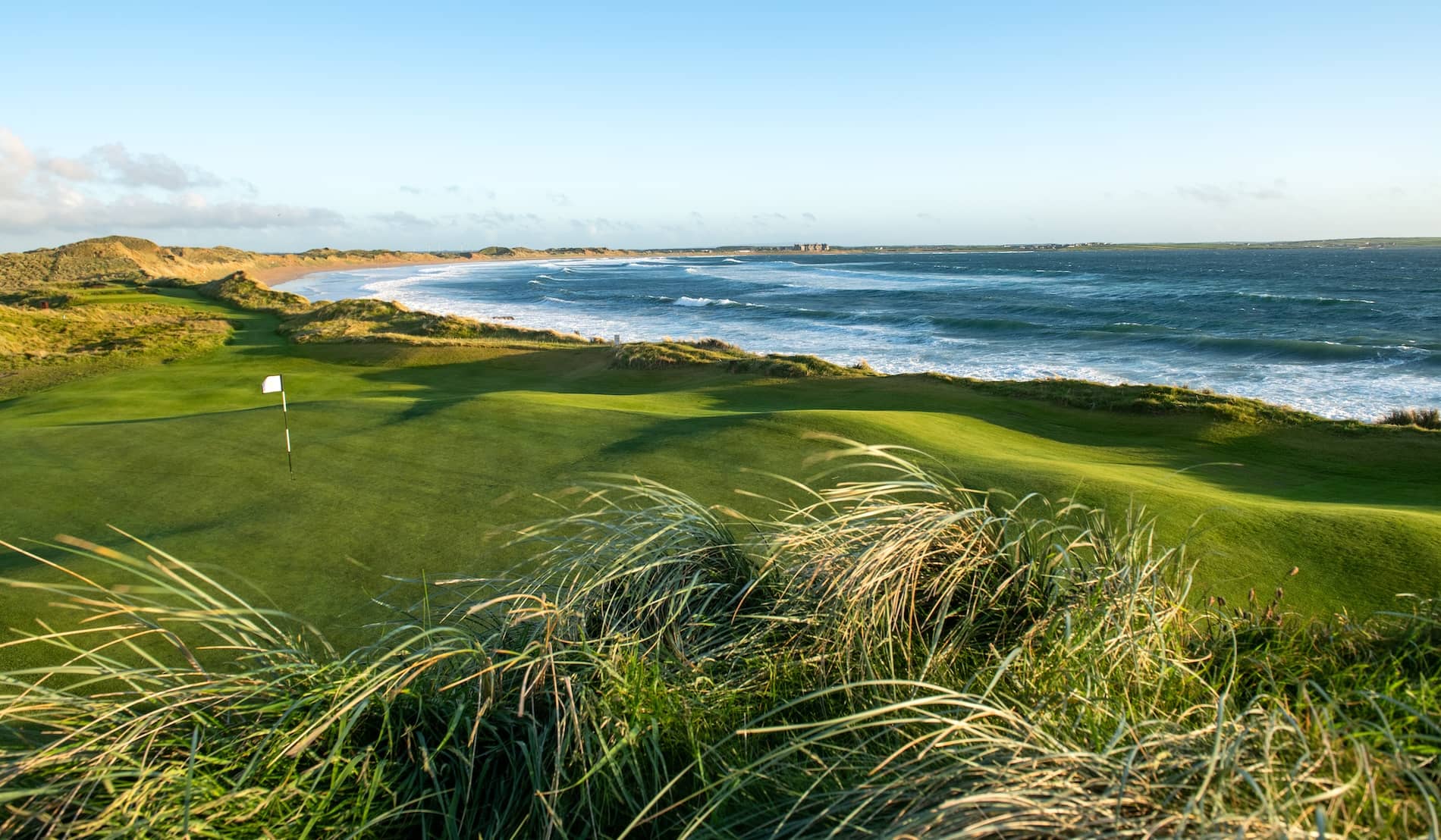 Green overlooking the Atlantic coastline at Doonbeg Golf Club in County Clare.