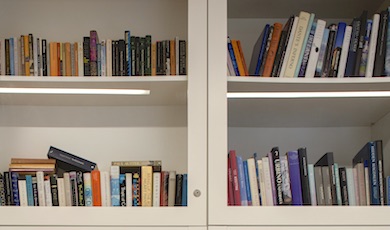 Close-up of colourful books neatly arranged on shelves in Seamus Heaney HomePlace, Bellaghy.