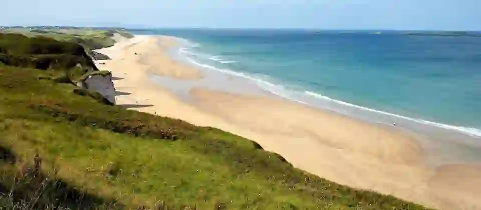 Panoramic view of Whiterocks Beach and golden sands on the Causeway Coast, County Antrim.