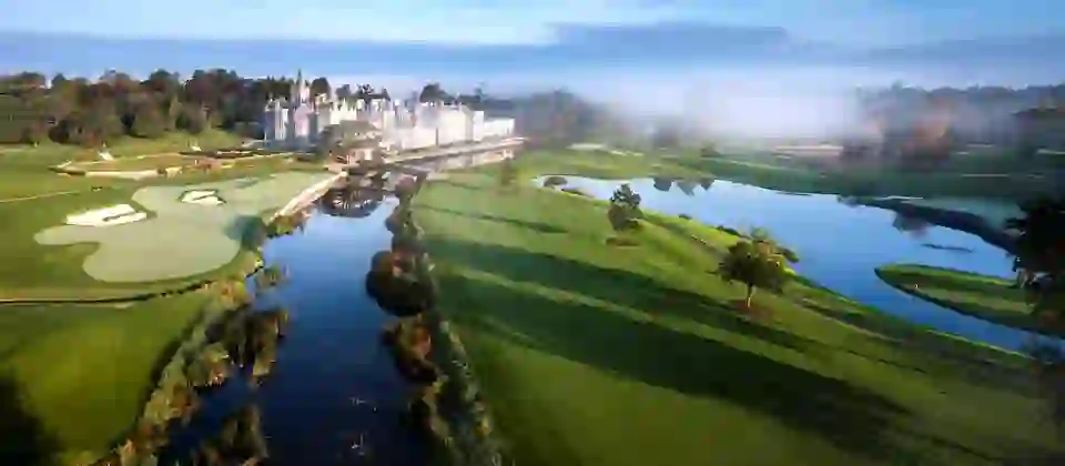 Adare Manor golf course in Limerick, Ireland, featuring manicured greens, lakes and the luxury manor hotel.