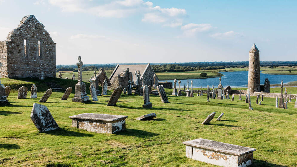 Ancient stone ruins and gravestones overlooking the River Shannon at Clonmacnoise.