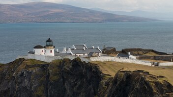 Scenic lighthouse accommodation on a cliffside at Clare Island, County Mayo, with panoramic coastal views.