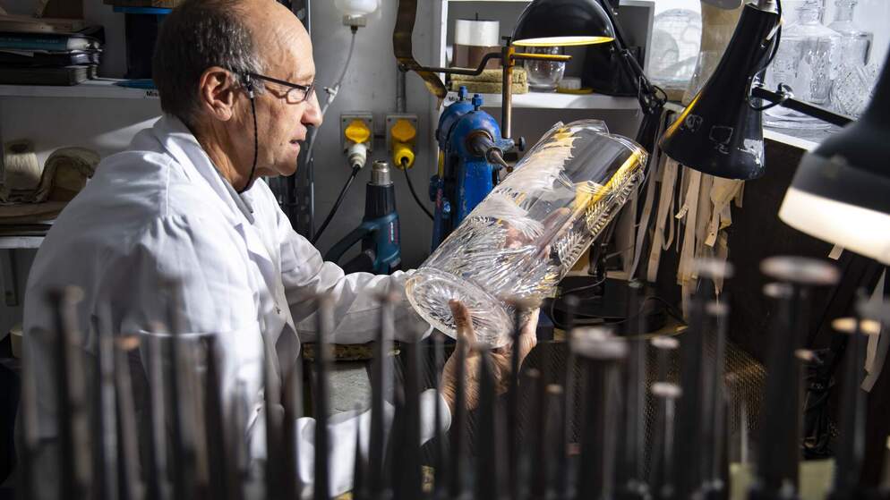 Un artisan grave un vase en cristal complexe à la main dans un atelier de Waterford Crystal.