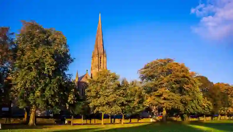 The Mall in Armagh city with tree-lined paths and the McClintock Monument.