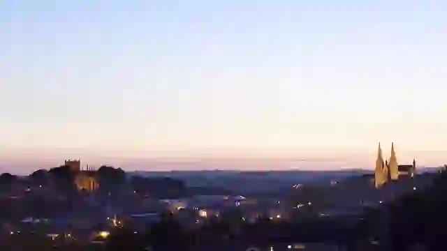 Armagh city skyline at dusk, with the twin St Patrick’s Cathedrals illuminated above the historic cityscape.