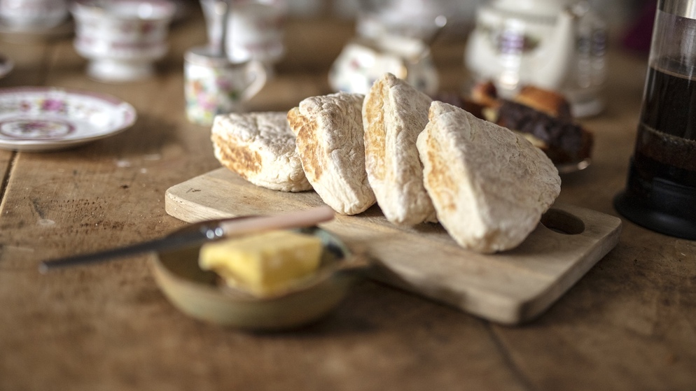 Freshly baked soda bread served on a rustic farmhouse table in Northern Ireland.