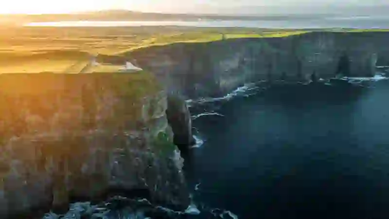 Sunset light over the Cliffs of Moher and Atlantic coastline in County Clare.