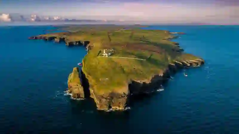 Aerial view of Loop Head lighthouse and rugged coastline in County Clare.