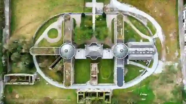 Cork City Gaol aerial view, historic prison with symmetrical layout and surrounding green grounds.
