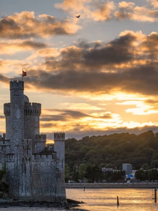 Blackrock Castle on the River Lee, Cork City, at sunset with dramatic sky and waterfront setting.