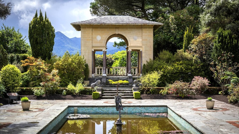 Italian gardens on Garnish Island, West Cork, with pavilion, fountain and mountain views in lush setting.