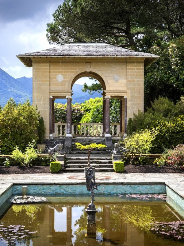 Italian gardens on Garnish Island, West Cork, with pavilion, fountain and mountain views in lush setting.