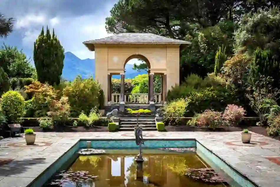 Italian gardens on Garnish Island, West Cork, with pavilion, fountain and mountain views in lush setting.
