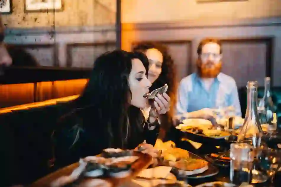 People enjoying oysters and local food in Cork restaurant, showcasing the city’s renowned food scene.