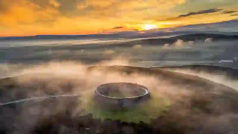 Grianán of Aileach ring fort surrounded by mist at sunrise in County Donegal.