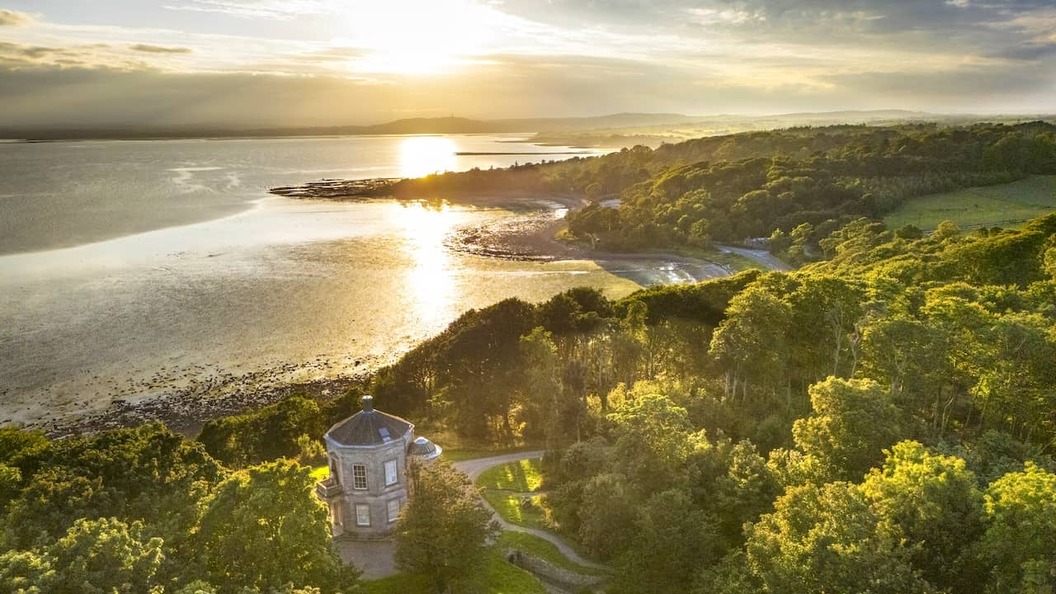 Mount Stewart House en de tuinen met uitzicht op Strangford Lough bij zonsondergang in county Down.
