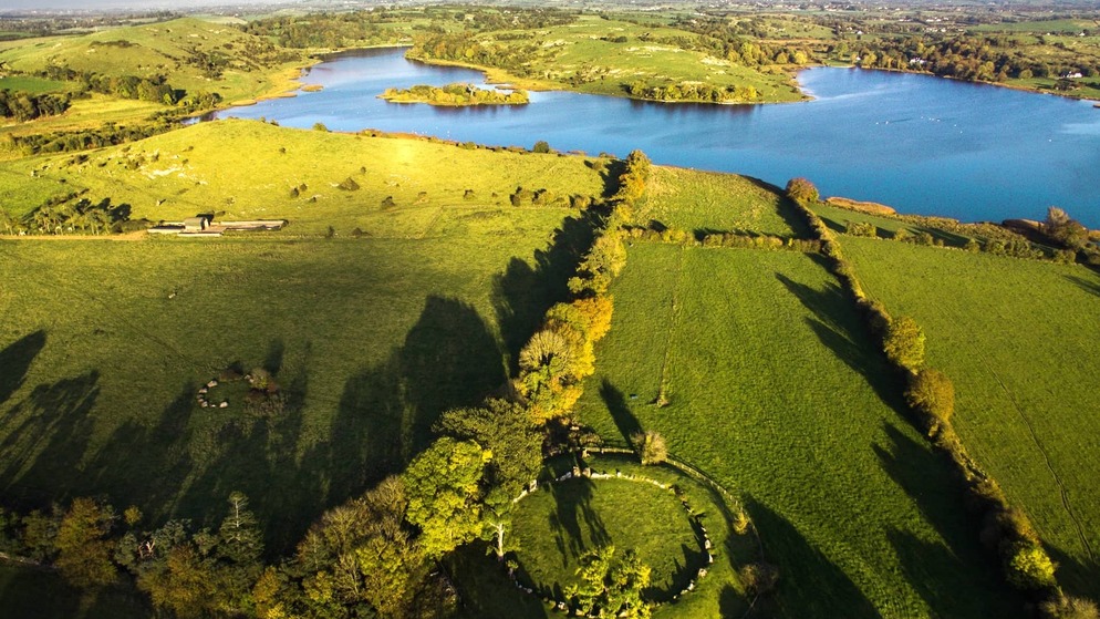 Lough Gur, County Limerick, with lake, green fields and ancient stone circle in scenic countryside.
