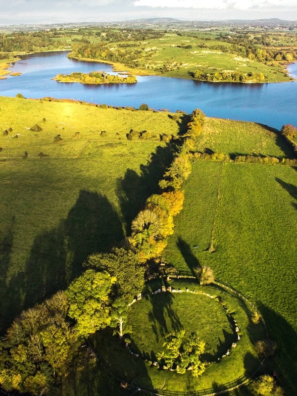 Lough Gur, County Limerick, with lake, green fields and ancient stone circle in scenic countryside.