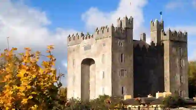 Bunratty Castle rising above autumn foliage in County Clare, one of Ireland’s best-preserved medieval tower houses.