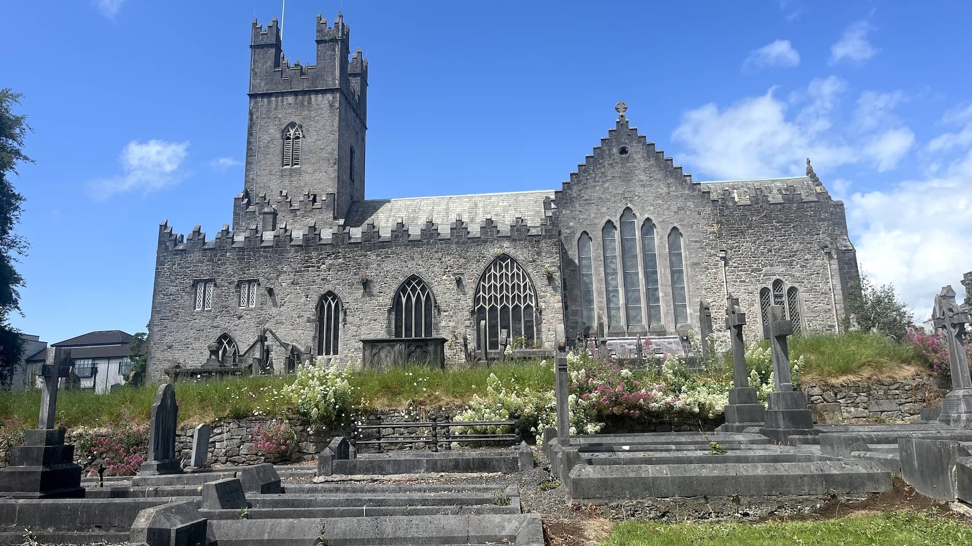 St Mary’s Cathedral and historic graveyard in Limerick city beneath a bright blue sky.
