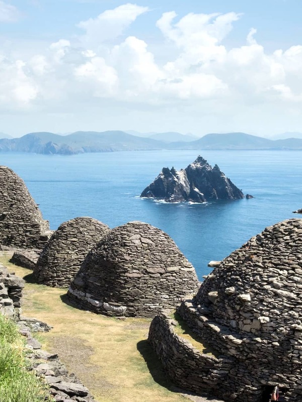 Stone beehive huts overlooking Skellig Michael and the Atlantic Ocean off the coast of County Kerry.