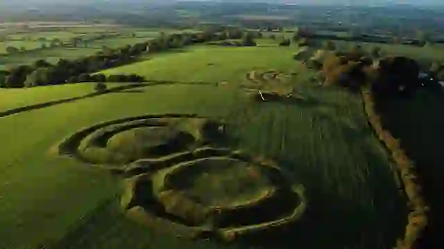 Aerial view of the ancient earthworks at the Hill of Tara in County Meath, surrounded by rolling green farmland.