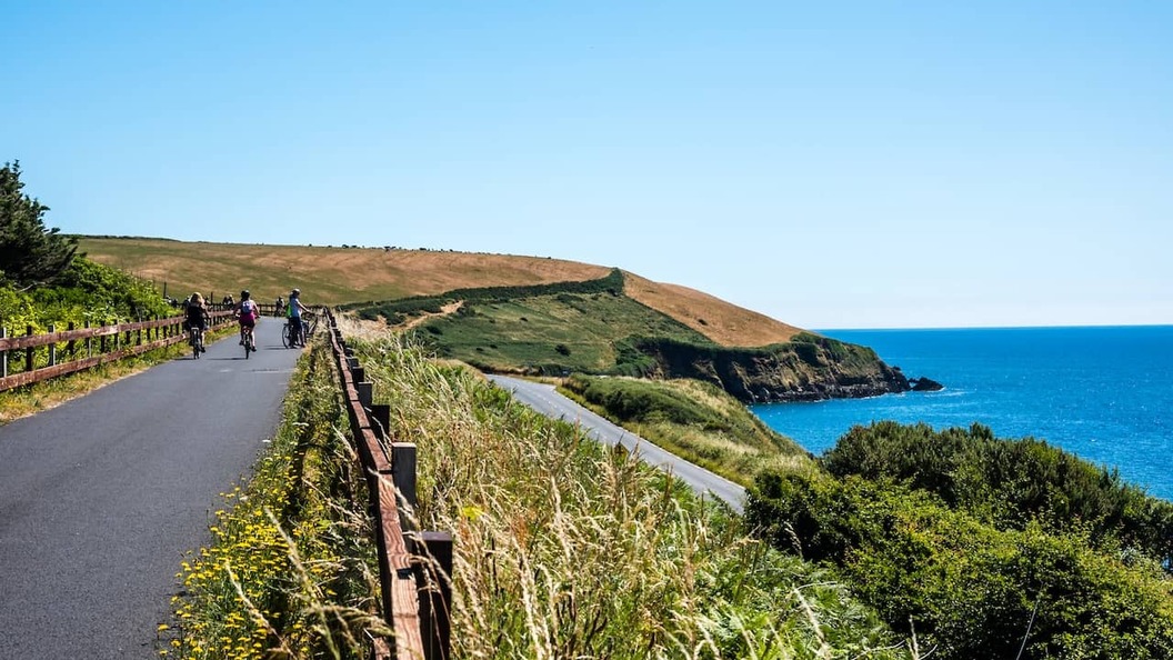 Waterford Greenway cycling route overlooking the rugged County Waterford coastline on a sunny day.