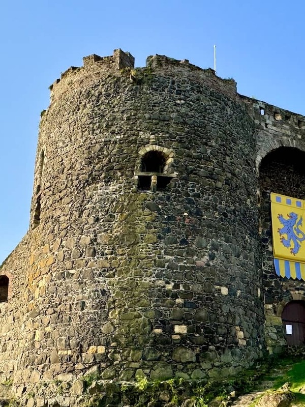 Carrickfergus Castle’s stone towers and battlements under a clear blue sky in County Antrim.