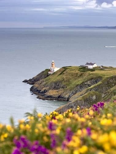 Howth Head with Baily Lighthouse on cliff edge overlooking Dublin Bay.
