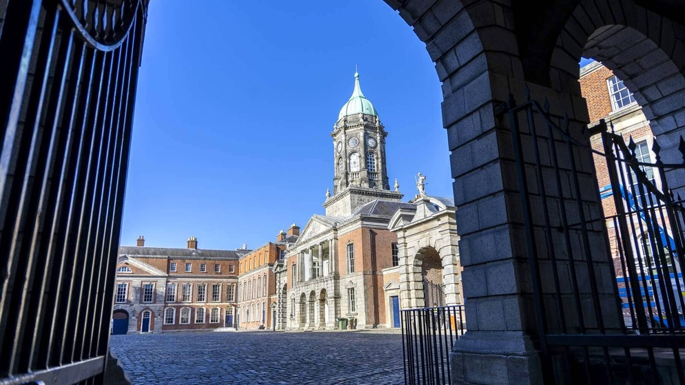 People enjoying ice cream by the River Liffey near Samuel Beckett Bridge in Dublin Docklands.