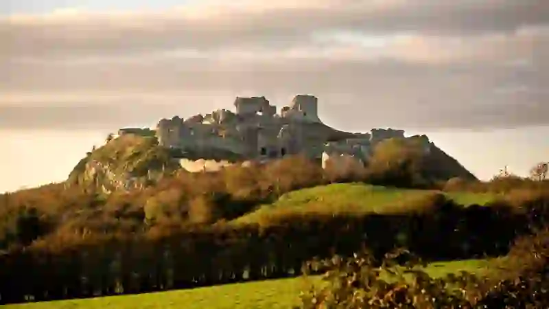Ruins of the Rock of Dunamase on a hilltop above green countryside in County Laois.