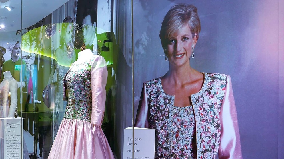 Fashion exhibit at the Museum of Style Icons, County Kildare, featuring a pink gown in a glass display beside a large portrait of Princess Diana.