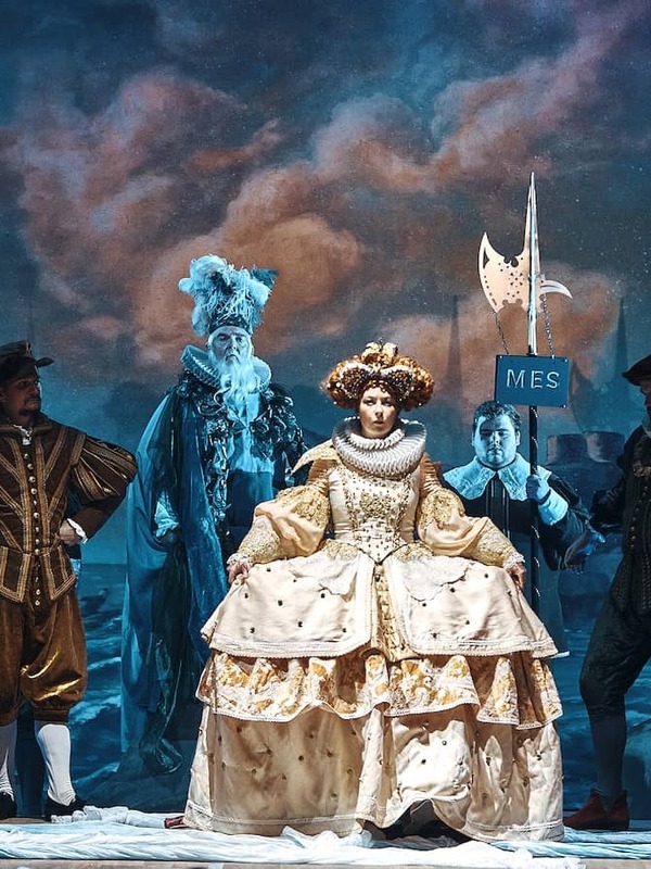 Opera performers in elaborate period costumes on stage during the Wexford Festival Opera.