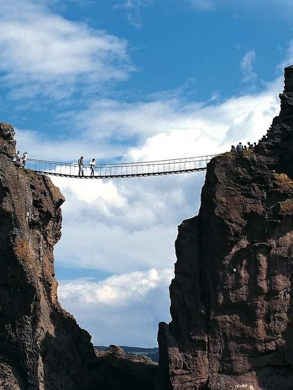 Carrick-a-Rede rope bridge suspended between cliffs above the sea on the County Antrim coast.