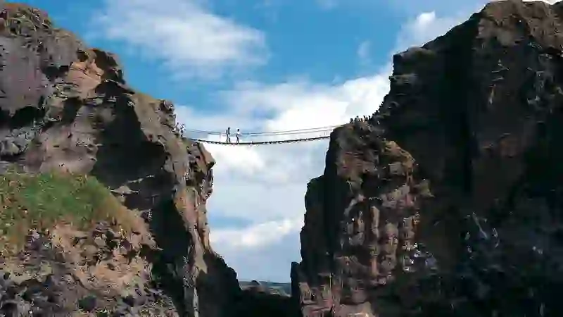 Carrick-a-Rede rope bridge suspended between cliffs above the sea on the County Antrim coast.