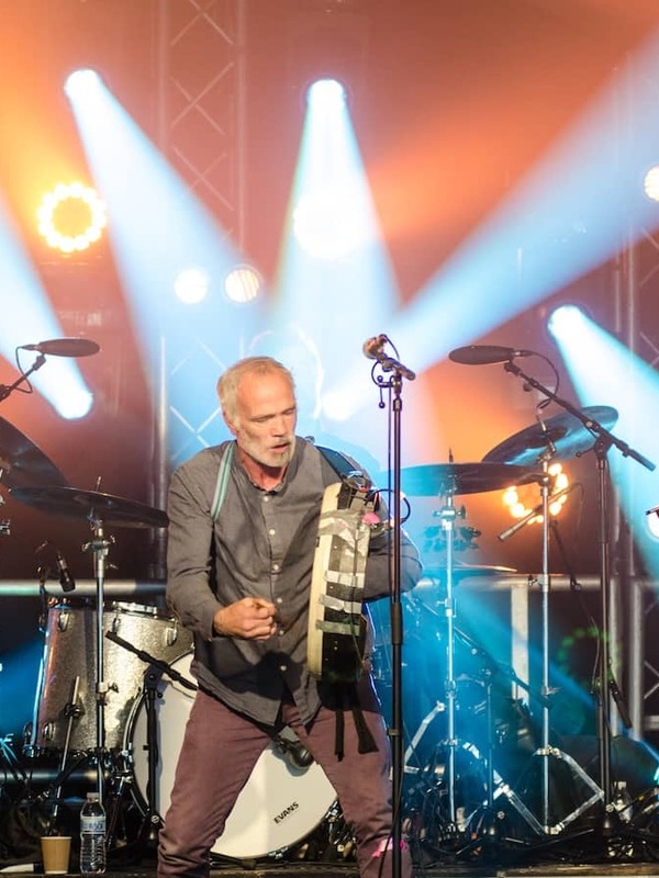 Traditional Irish band performing live under bright stage lights at Cathedral Quarter Arts Festival in Belfast.
