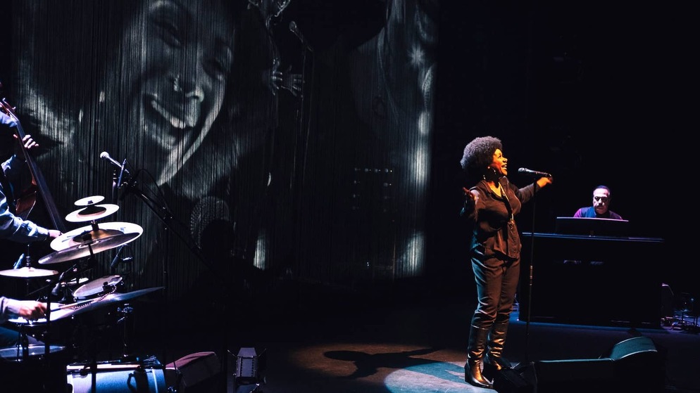 Soul singer performing with pianist and jazz band at Belfast International Arts Festival.